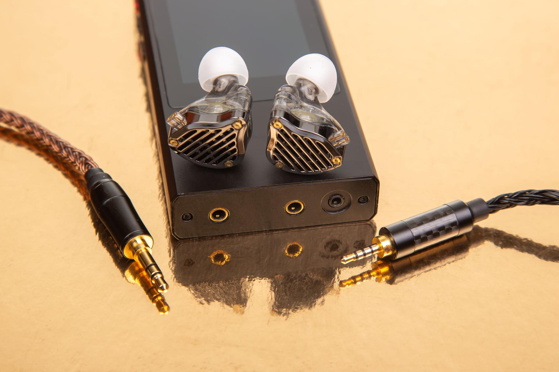 High-fidelity audio setup featuring stylish in-ear monitors and a sleek music player